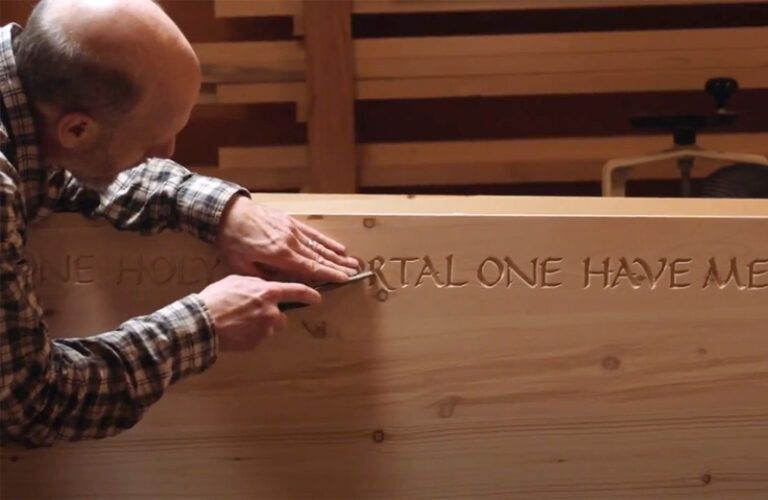 Marcus Daly works at handcrafting a coffin.
