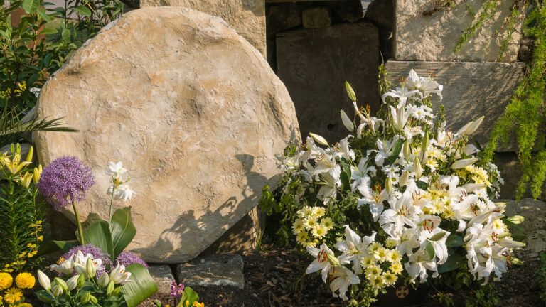 The empty tomb, festooned with white lilies