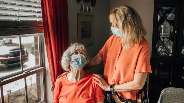 A family caregiver with patient; Getty Images