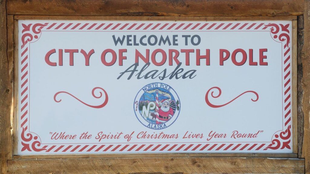 The real North Pole wooden city sign with the towns motto