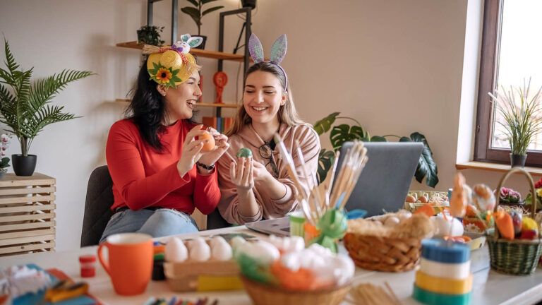 Two friends do their Easter tradition of painting eggs and making Easter baskets